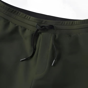 Light grey men's moisture-wicking quick-dry athletic t-shirt worn by a person with glasses, visible sleeves, and outdoor shoes.