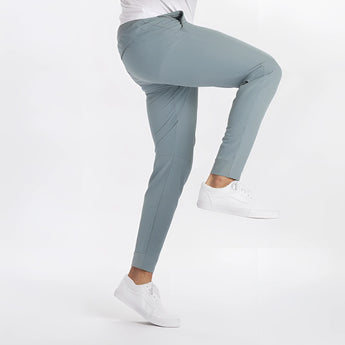 Men's light grey moisture-wicking quick-dry athletic t-shirt worn by a model paired with jeans.