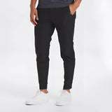 Man wearing light grey moisture-wicking quick-dry athletic t-shirt with jeans, posing in a sporty manner.