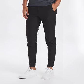 Man wearing light grey moisture-wicking quick-dry athletic t-shirt with jeans, posing in a sporty manner.