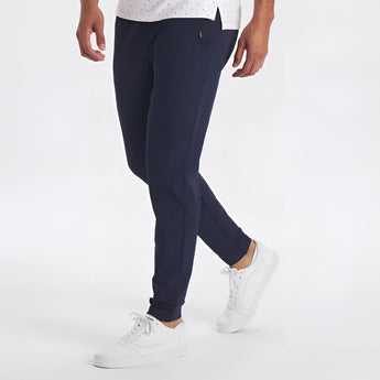 A man wearing a light grey moisture-wicking quick-dry athletic t-shirt and jeans with his arms slightly bent, showcasing the shirt's short sleeves and comfortable fit.