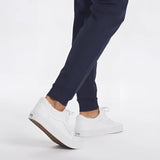 Men's light grey moisture-wicking quick-dry athletic t-shirt worn by a person in active pants standing on a floor.