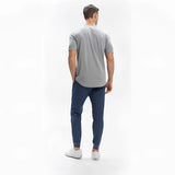 Men's light grey moisture-wicking quick-dry athletic t-shirt modeled by a person, focusing on shoulder, sleeve, and waist areas.