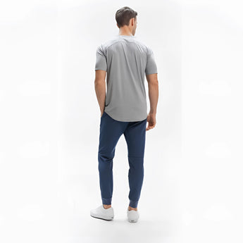 Men's light grey moisture-wicking quick-dry athletic t-shirt modeled by a person, focusing on shoulder, sleeve, and waist areas.
