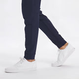 Men's light grey moisture-wicking quick-dry athletic t-shirt worn by model with denim jeans, showcasing sleeve and sportswear design.