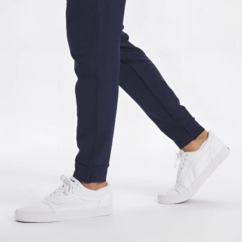 Men's light grey moisture-wicking quick-dry athletic t-shirt worn by model with denim jeans, showcasing sleeve and sportswear design.