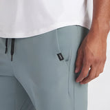 Light grey men's moisture-wicking quick-dry athletic t-shirt, short sleeves, crew neck, worn by a standing model.