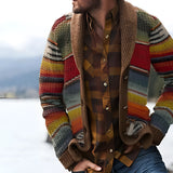 Men's multicolor striped heavyweight shawl collar cardigan worn by a bearded man, paired with jeans and a dress shirt, featuring plaid and tartan patterns, suitable for autumn and winter.