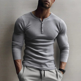 Men's muscle-fit grey Henley shirt in size XL, featuring a slim-fit design with long sleeves and a thermal texture, modeled by a person showcasing the shirt's neckline and sleeve details.