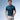Men's teal embroidered polo shirt being worn by a person standing with sunglasses, showcasing short sleeves and a stylish summer design.