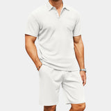 Men's navy blue polo and shorts set featuring a breathable design, perfect for a casual summer outfit. The set includes a short-sleeved polo shirt and matching shorts.
