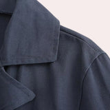 Men's navy blue wool double-breasted peacoat featuring a classic design with a notched collar, button-front closure, and long sleeves, suitable for winter fashion.