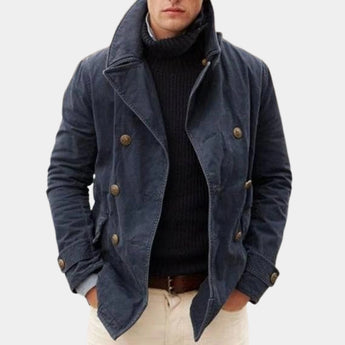 Men's navy blue wool double-breasted peacoat featuring wide lapels, button closure, and long sleeves, styled for winter fashion.
