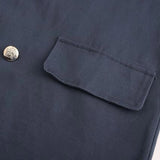 Men's navy blue wool double-breasted peacoat with a classic collar and button detailing, showcasing a timeless winter fashion style.