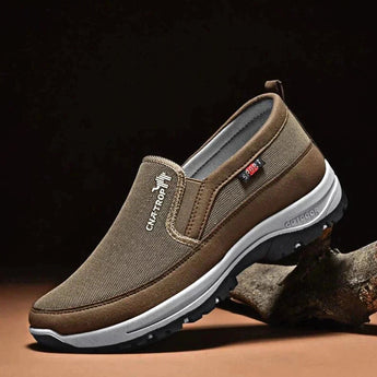 Men's navy slip-on waterproof walking shoes with lightweight and anti-slip features, designed for outdoor activities.