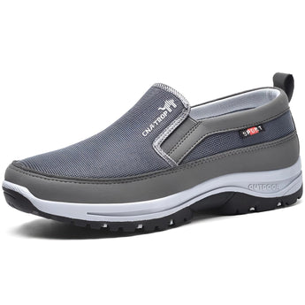 Men's navy and grey slip-on walking shoes with a lightweight design, featuring anti-slip soles suitable for outdoor activities.
