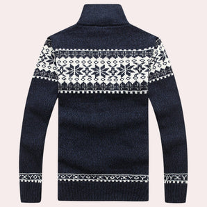 Men's Nordic wool sweater in dark blue with snowflake pattern and turtleneck collar, featuring long sleeves and intricate textile design.