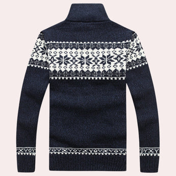 Men's Nordic wool sweater in dark blue with snowflake pattern and turtleneck collar, featuring long sleeves and intricate textile design.