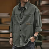Men’s oversized olive green utility shirt made of cotton, featuring long sleeves, a collar, and a casual design. The shirt is styled in a military green color, suitable for a relaxed or casual look.