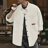 Men's oversized olive green cotton utility shirt, featuring a casual long sleeve design, with a classic collar and relaxed fit.