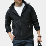 Men's black hooded cargo jacket in 3XL size, featuring a sleek design with a front zipper, long sleeves, and a collar; model wearing the jacket has an arm raised, showcasing the garment's fit and style.