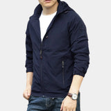 Men's olive green hooded cargo jacket in lightweight material, suitable for urban settings, featuring long sleeves, a collar, and ample pocket space.