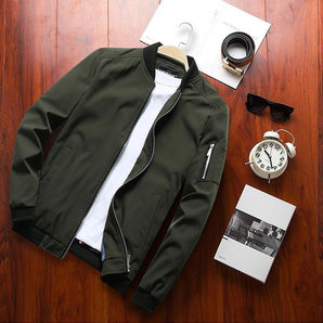 Men's olive green lightweight bomber jacket featuring a zipper pocket, with a close-up view highlighting the jacket's sleeve, collar, and textured fabric.