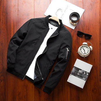 Men's olive green lightweight bomber jacket with zipper pocket, featuring a collar and long sleeves, displayed on a model wearing a white dress shirt underneath.