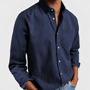 Men's olive green rugged outdoor shirt with long sleeves, featuring a casual design suitable for outdoor activities. The shirt is worn by a person with arms slightly bent at the elbows, showcasing the fabric's durability and comfort.