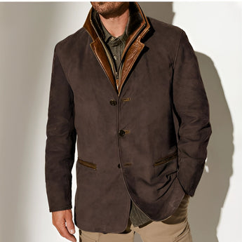 Men's olive green suede blazer featuring a classic collar and button closure, designed as a luxury sport coat. The garment is styled with long sleeves and has a sophisticated, high-fashion design.