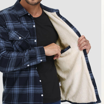 Men's orange plaid flannel shirt with long sleeves and a classic tartan pattern, shown on a model displaying the shirt's shoulder and waist areas.