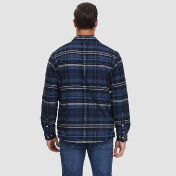 Men's orange plaid flannel shirt with long sleeves, featuring a classic tartan pattern.