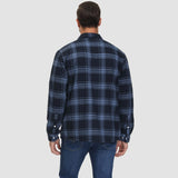 Men's orange plaid flannel shirt with long sleeves featuring a tartan pattern, worn casually.