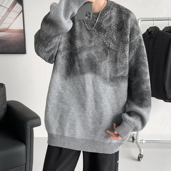 
A man wearing an oversized black chunky knit woolen crewneck sweater, standing with his shoulders visible, showing the texture of the knitted fabric and the comfortable fit around the neck and sleeves.