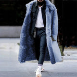 Men's oversized blue faux fur longline coat with a luxurious urban design, featuring a wide collar and long sleeves, styled for winter wear. The coat extends to the knees, offering a fashionable and warm outerwear option.