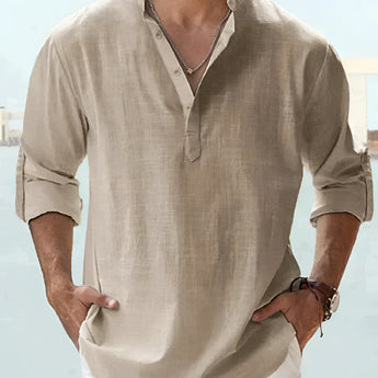 Man wearing a pink linen Henley shirt, lightweight and breathable, paired with khaki pants, showcasing the shoulder, sleeve, and neck details.