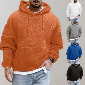 Men's quilted cable knit hoodie in a combination of white and blue colors, featuring a zip closure, kangaroo pocket, and long sleeves. The hoodie is worn by a standing human model, showcasing its fashionable design.