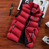 Men's red insulated puffer vest, lightweight and water-resistant, designed for hiking, size 8XL, displayed on a couch with wooden elements in the background.