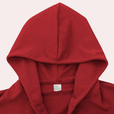 Men's red oversized hoodie featuring long sleeves, a hood, and a relaxed street style design made from soft fabric for comfort.