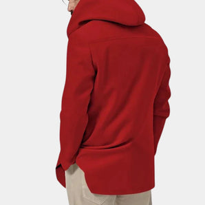 Men's red oversized hoodie designed in street style, showcasing soft fabric with long sleeves and a comfortable fit, worn by a model pairing it with jeans.