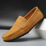 Men's brown suede designer loafers displayed on a model's foot, showcasing luxury casual shoes in a stylish and comfortable design.