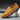 Men's brown suede designer loafers displayed on a model's foot, showcasing luxury casual shoes in a stylish and comfortable design.
