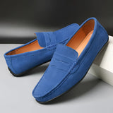 Men's red suede designer loafers with a luxury casual style, featuring electric blue elements and synthetic rubber soles, shown on a human leg.
