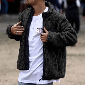Men's Sherpa Zip-Up Fleece Jacket in Black, 3XL, worn by a model. The jacket is styled as a dark gray winter coat with a focus on its outerwear features and long sleeves. The model is also wearing sunglasses and a t-shirt beneath the jacket.