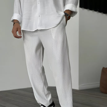 Men's slim fit beige pinstripe trousers paired with a white dress shirt, featuring a lightweight design suitable for summer fashion.