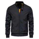 Men's slim fit black bomber jacket in lightweight urban style featuring long sleeves, a sleek collar, and button detailing.