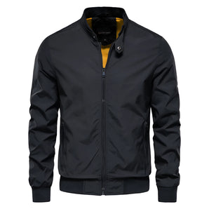 Men's slim fit black bomber jacket in lightweight urban style featuring long sleeves, a sleek collar, and button detailing.