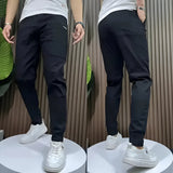 Men's slim fit black cargo pants with a tapered design, showcasing a stylish and versatile look suitable for various occasions.