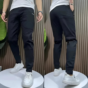 Men's slim fit black cargo pants with a tapered design, showcasing a stylish and versatile look suitable for various occasions.