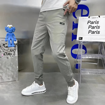 Men wearing slim fit black cargo pants with a tapered design, showcasing their stylish and versatile appearance.